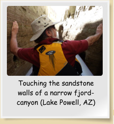 Touching the sandstone walls of a narrow fjord-canyon (Lake Powell, AZ)